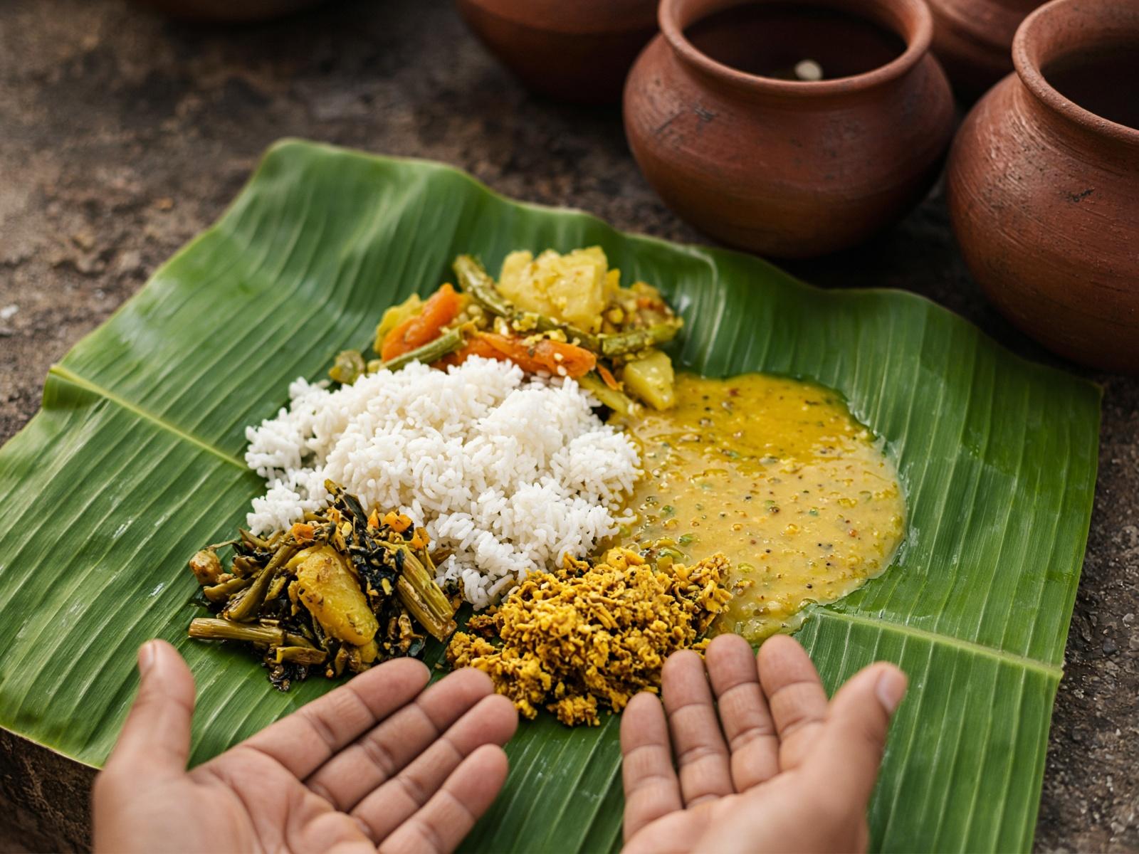 Mahaprasad on a banana leaf beside an earthen pot.