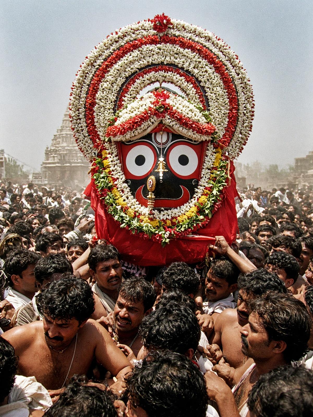 Pahandi: the flower tahia and the round eyes of Jagannath carried through a crowd.